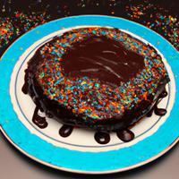 Cake with chocolate drizzle and sprinkles