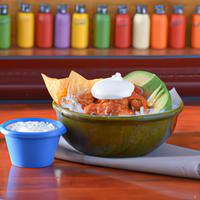 Chipotle chicken burrito bowl with guacamole and sour cream