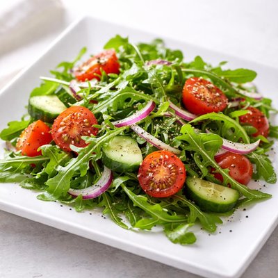 Arugula salad with tomatoes and cucumbers