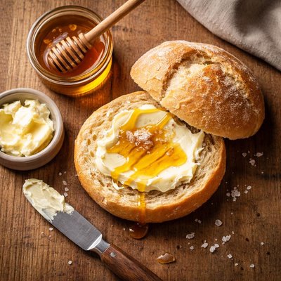 Bread roll with butter and honey
