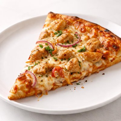 Slice of pizza with chicken and cheese