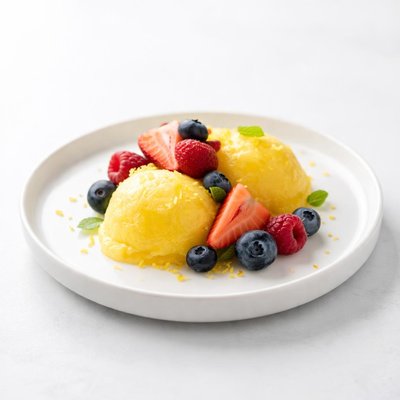 Image of Lime Mango Sherbet Topped with Fresh Berries
