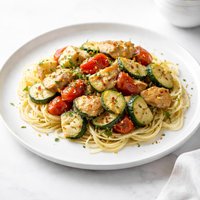 Sauteed Chicken Zucchini Artichokes and Tomatoes Over Pasta