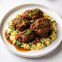 Smothered Oxtails Over Spinach and Sweet Corn Mash