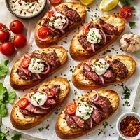 Steak Served on Parmesan Toasts with Sour Cream Onion Garlic Sau